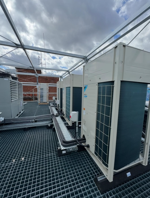ETS Envirotemp Services - Row of Daikin outdoor air conditioning units and pipework on a rooftop steel platform; air conditioning installations in Kent, Essex and London